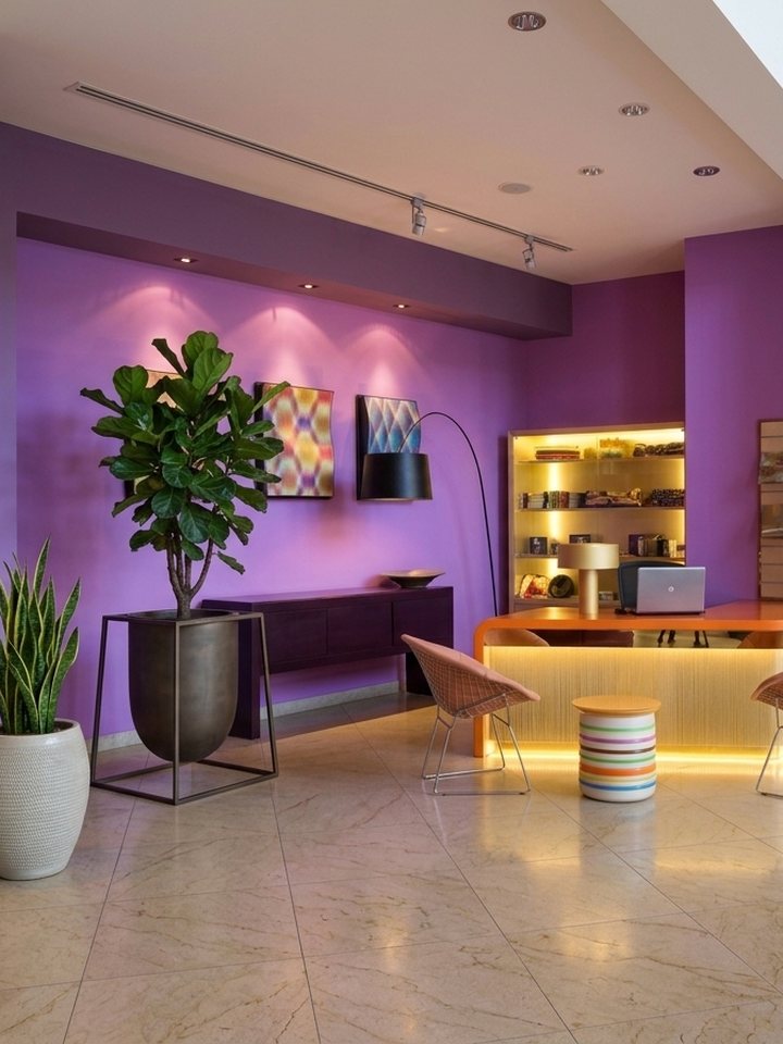 Boutique reception with violet feature wall and backlit desk