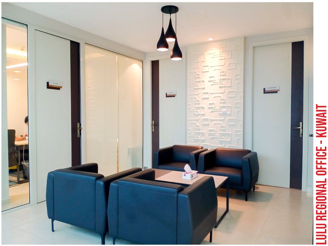 Glass system partition with framed doors in an office lounge