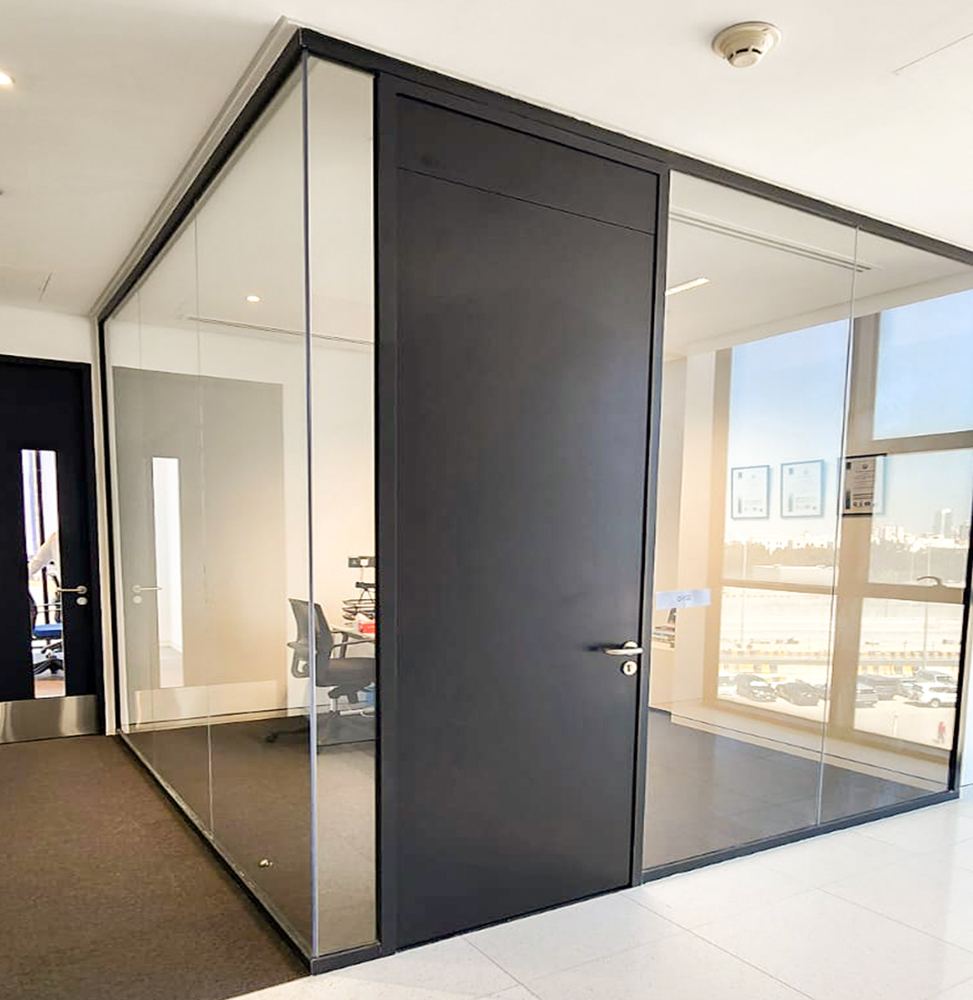 Glass system partition with full-height pivot door